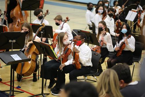 Orchestra students play instruments